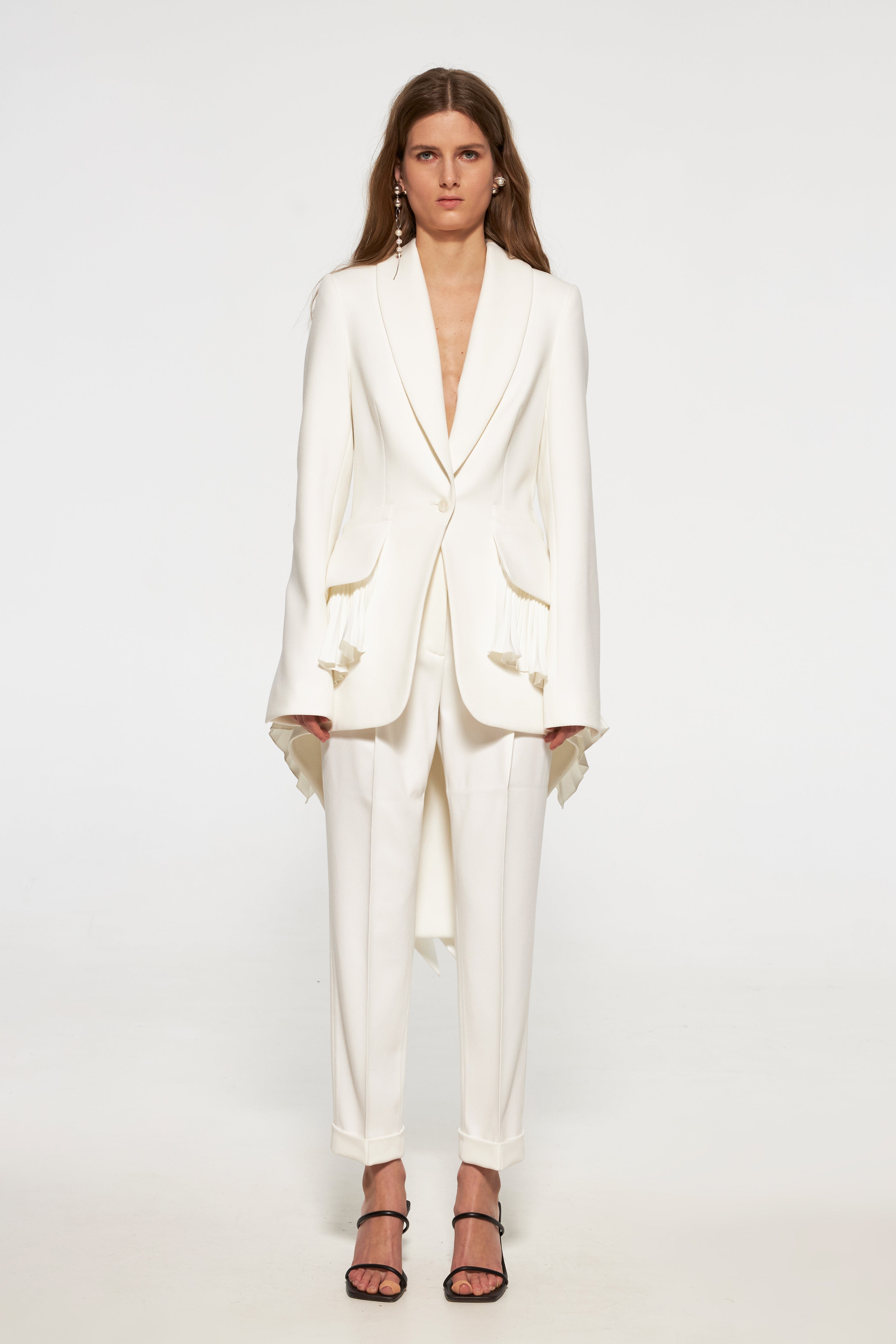 Tuxedo jacket with long back and pleated ruffles