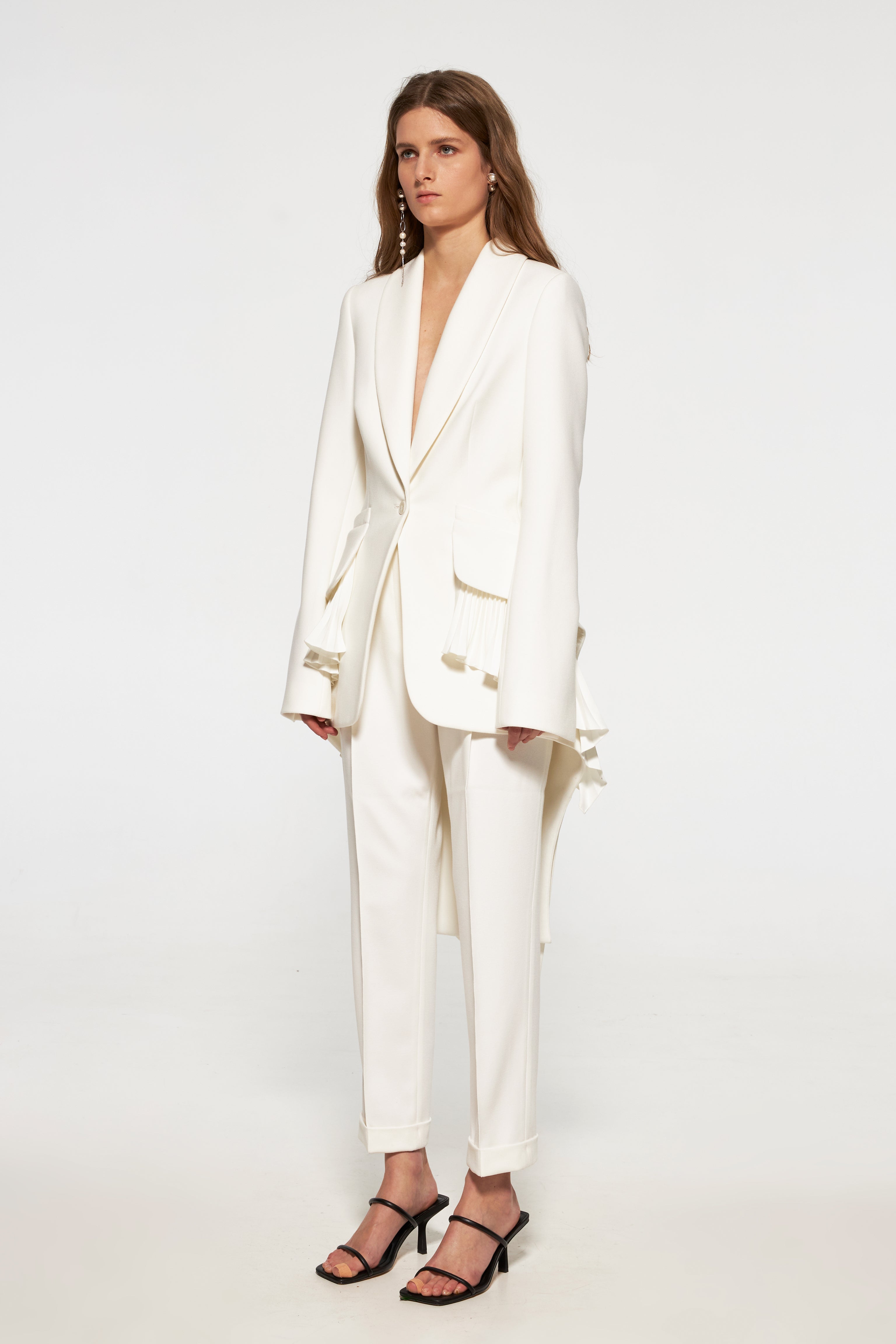 Tuxedo jacket with long back and pleated ruffles