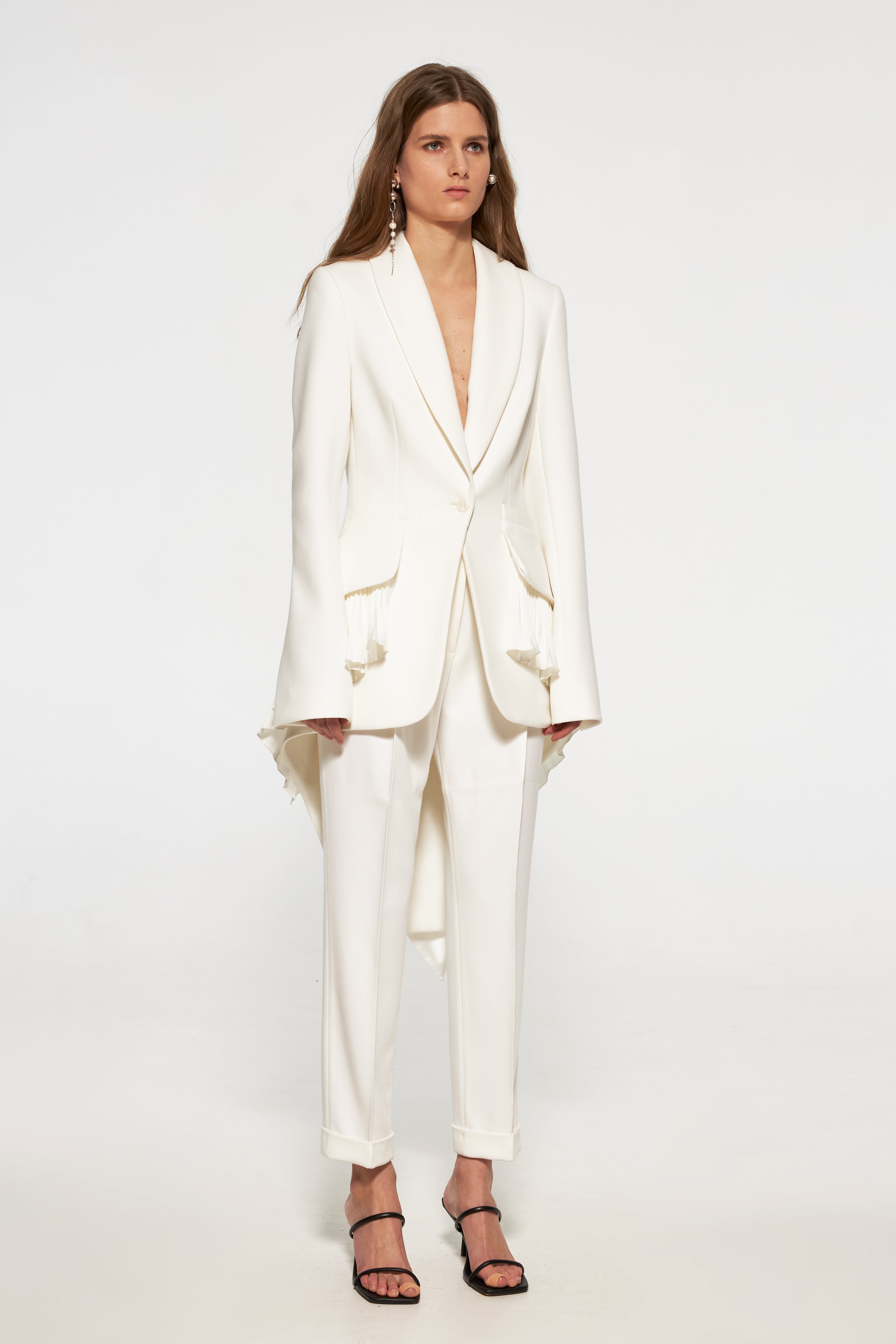 Tuxedo jacket with long back and pleated ruffles