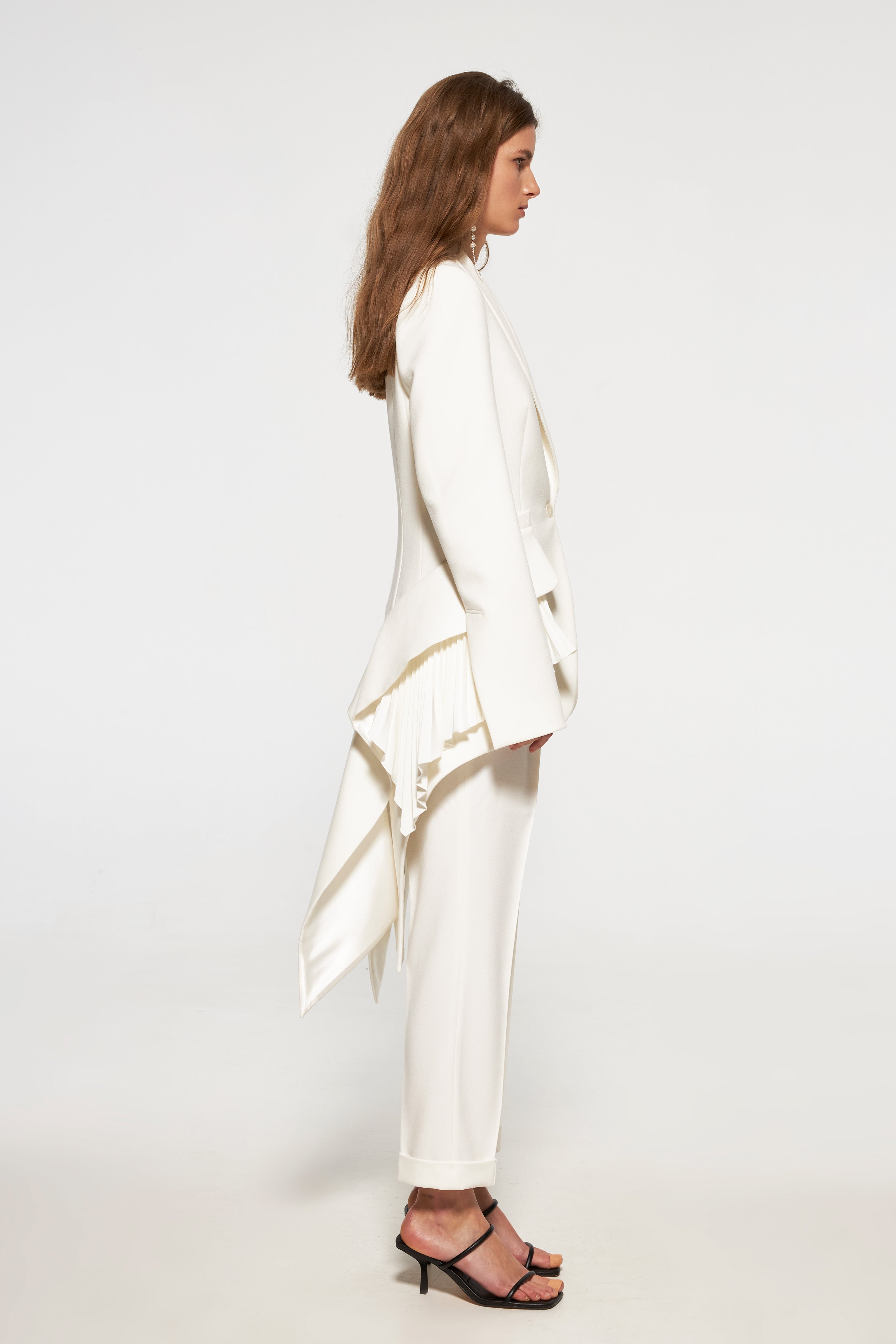 Tuxedo jacket with long back and pleated ruffles