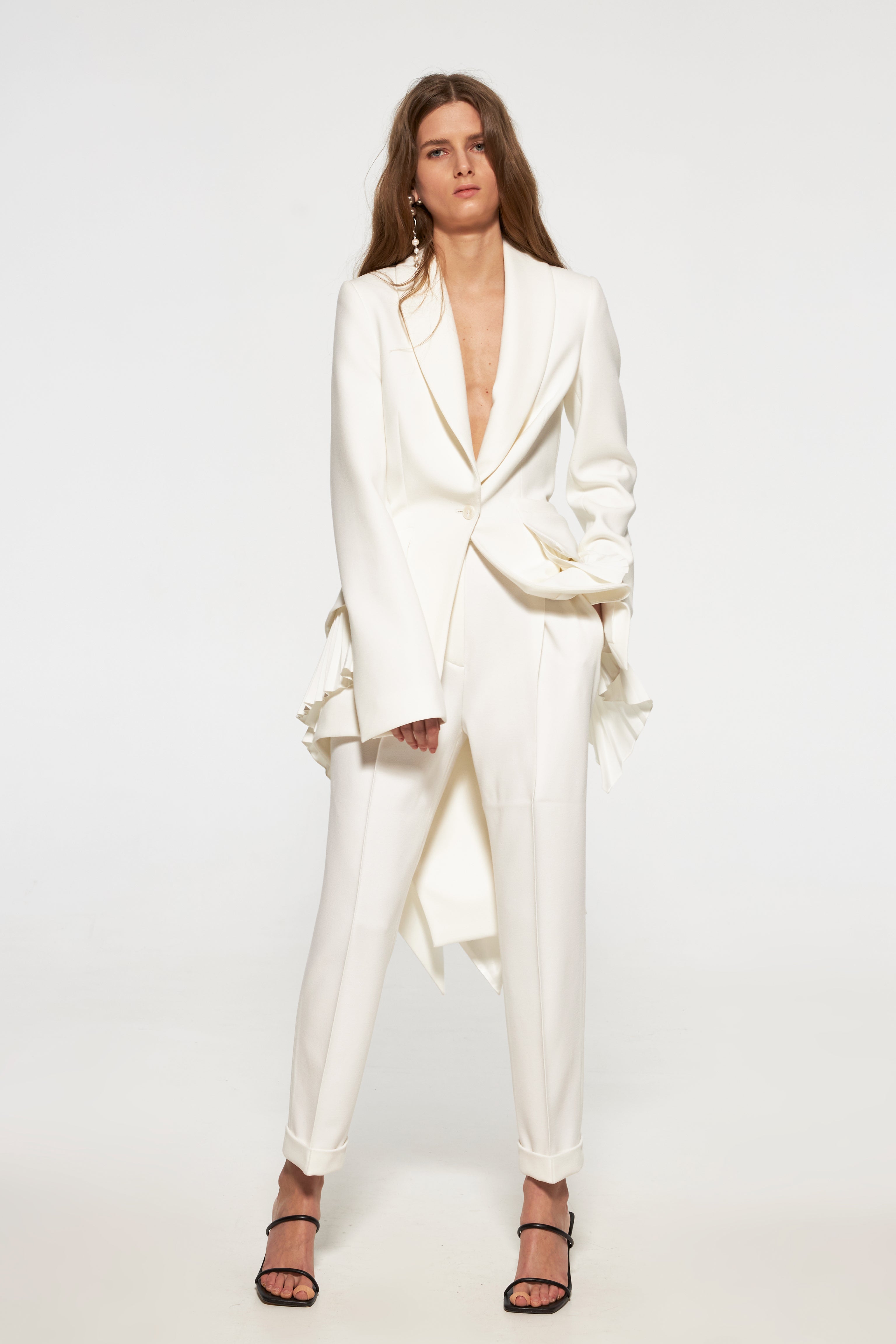 Tuxedo jacket with long back and pleated ruffles